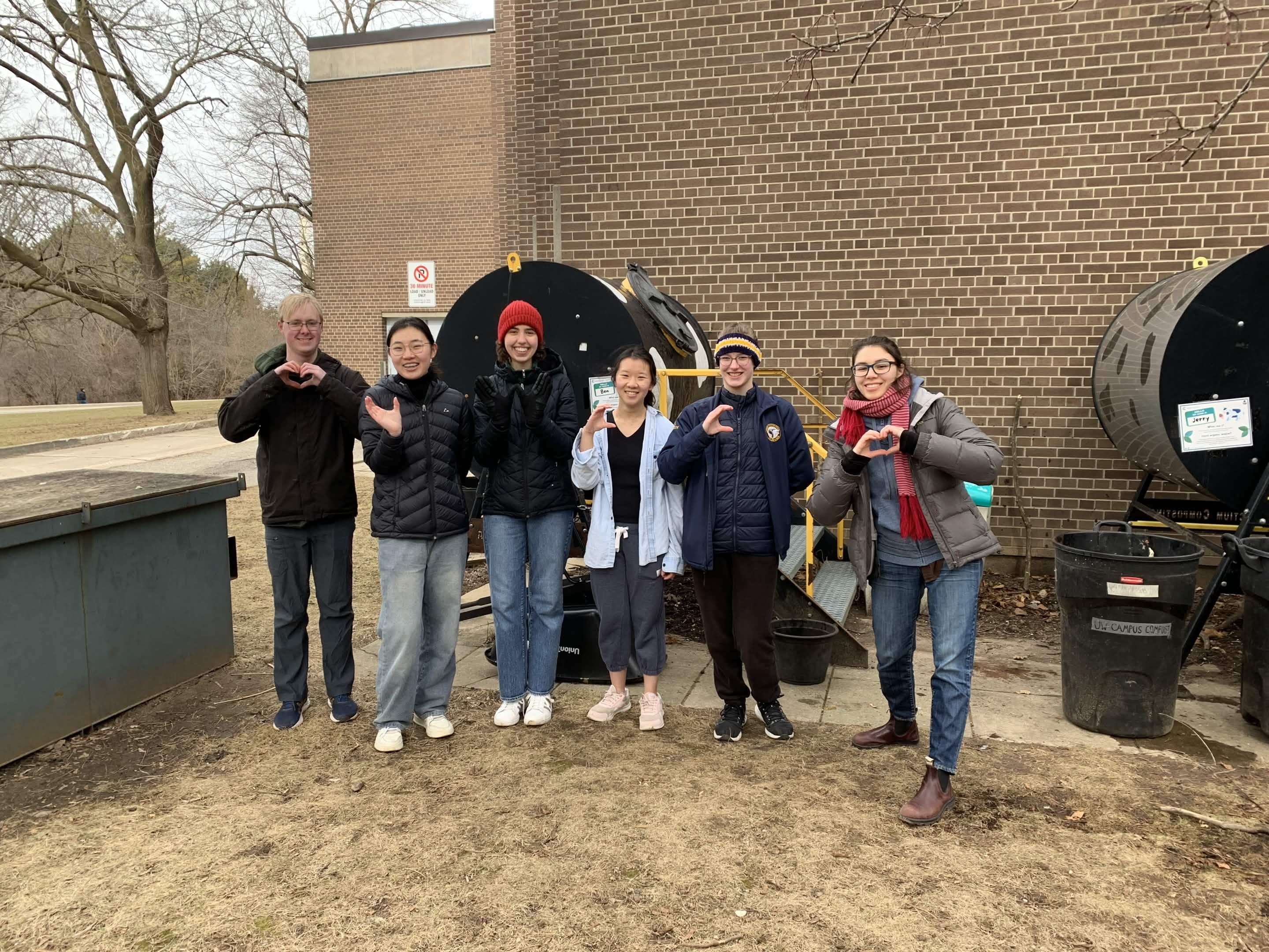 Chloe Sullivan and a group of students posing together in the environment
