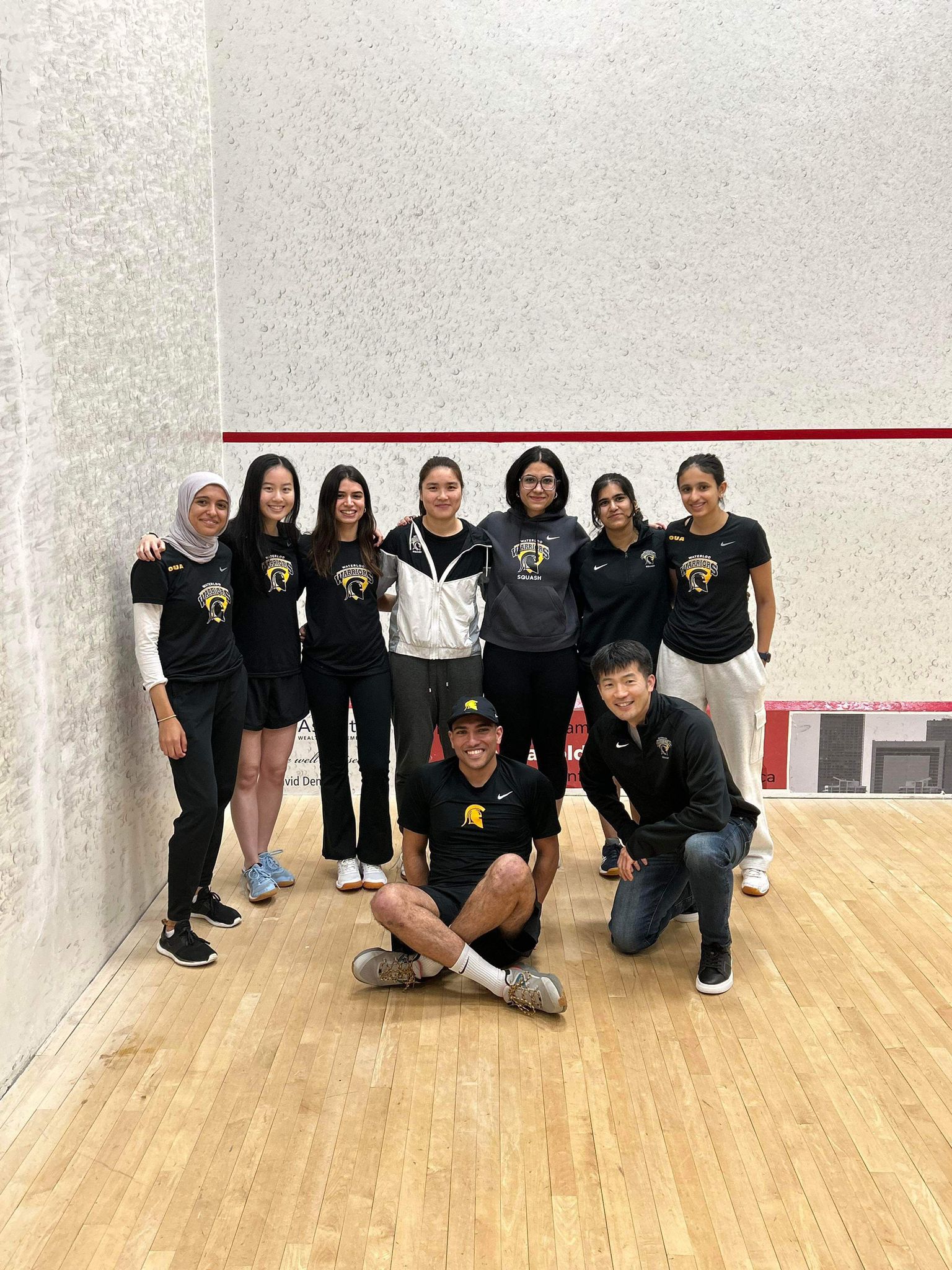 Squash team photo on the court. 