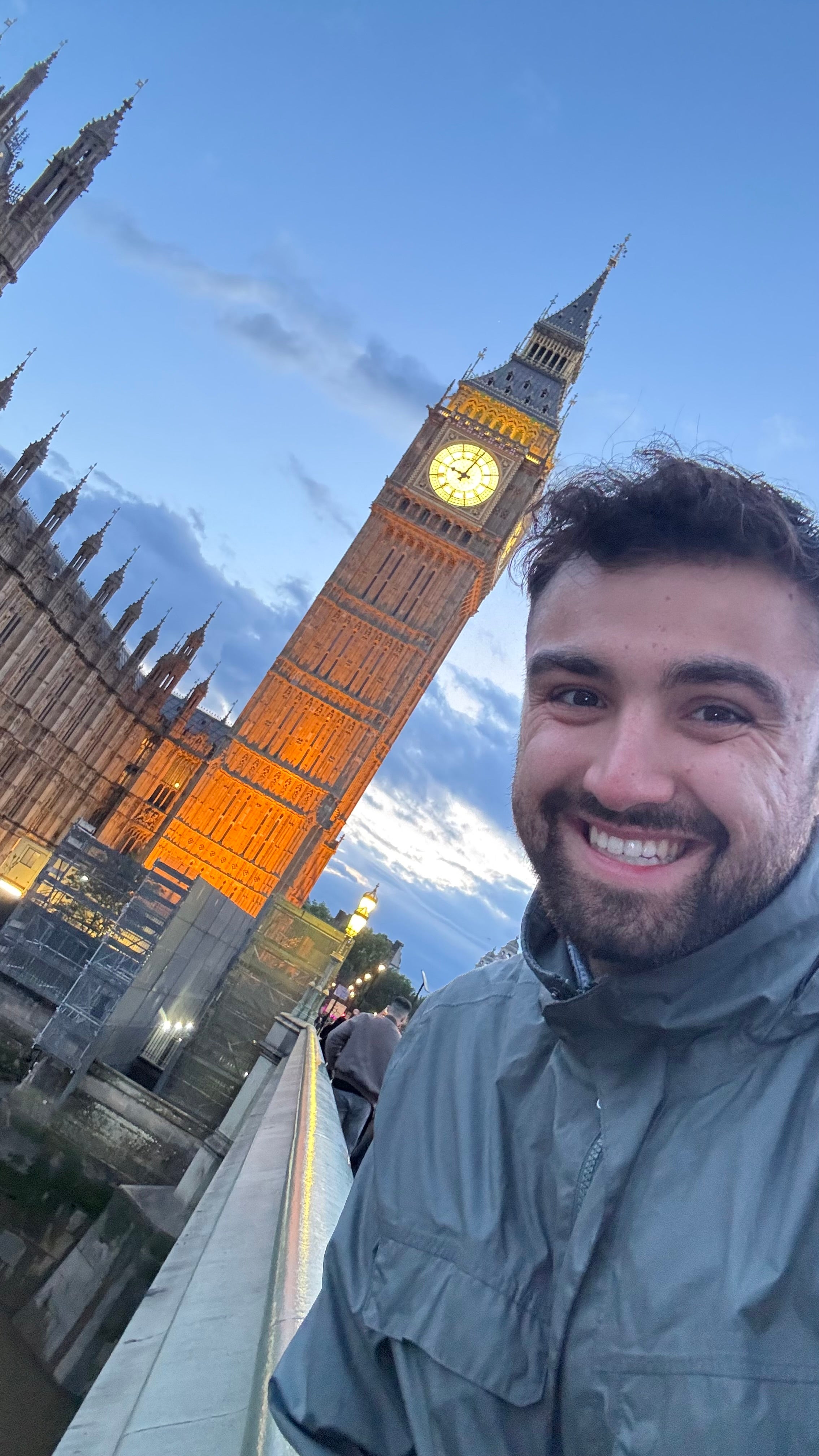 Ethan Rad posing with Big Ben in London during the evening