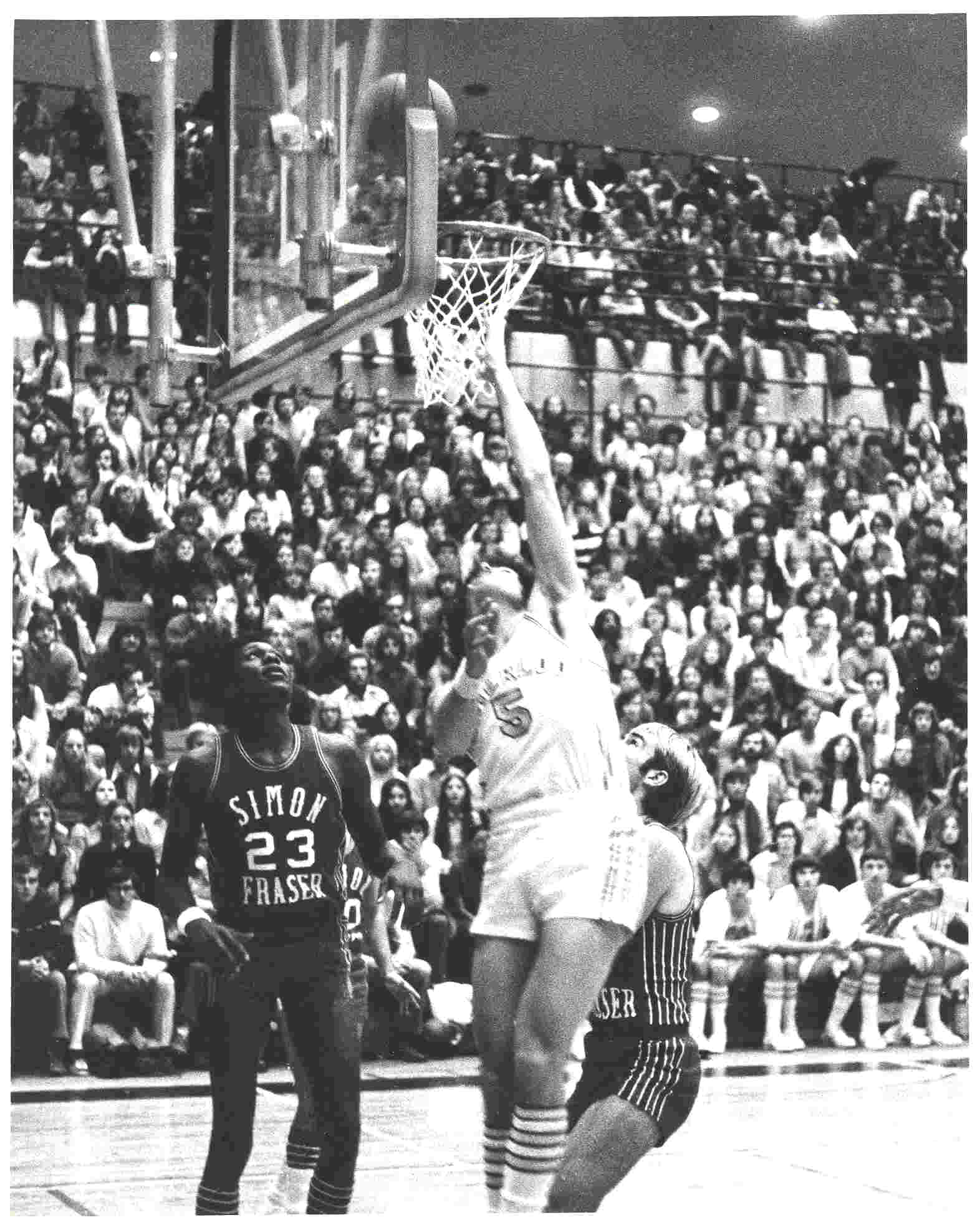 Waterloo Warriors player Jeff Scott tries to make a layup during a basketball game 