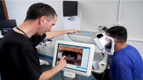 Dr. James Wolffsohn looking at an eye on a digital screen.