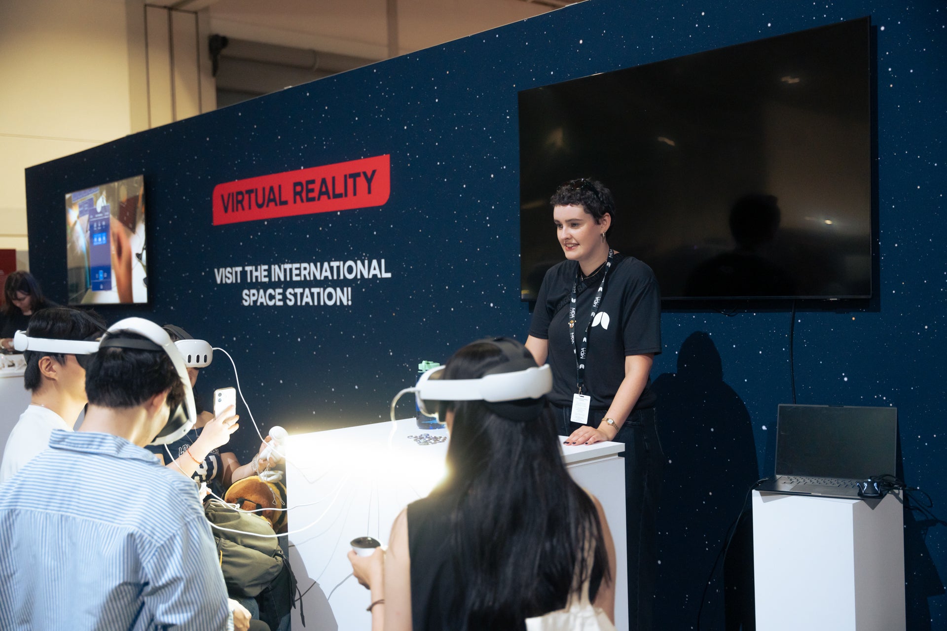 Emily Pittman guide visitors through a virtual reality tour of the International Space Station
