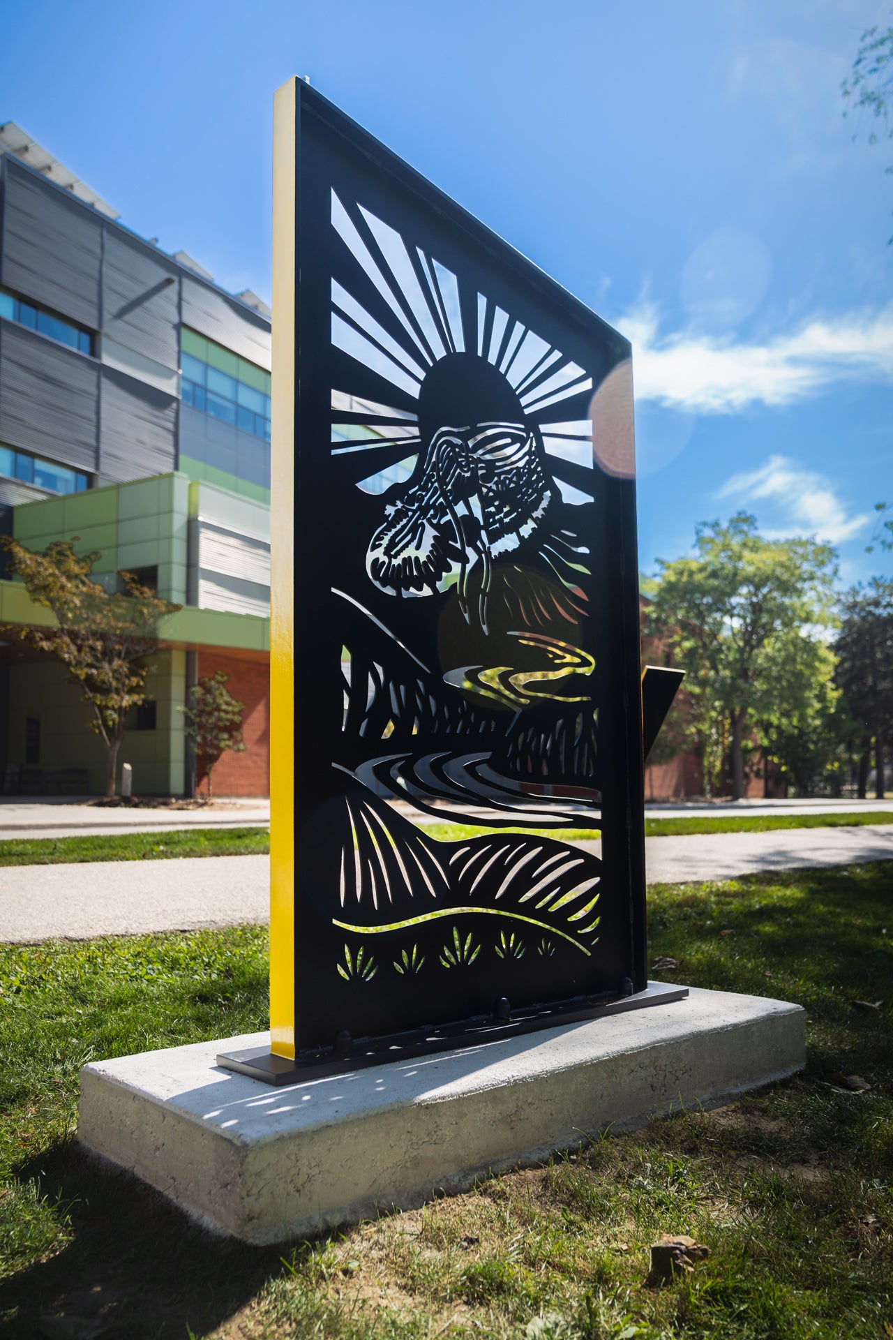 Moccasin Identifier Treaty Marker displayed across from Environment 3 building in daylight