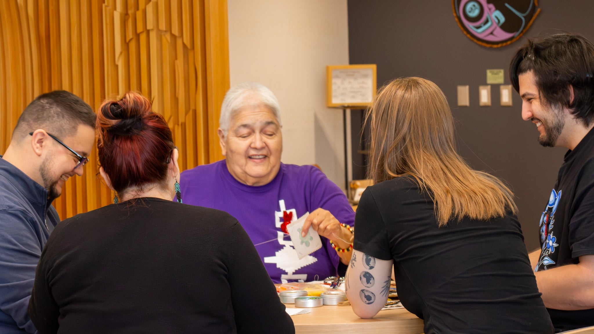 In the Visiting Aunties Program, Rhea Green connects with students and staff while they create their own beadwork 