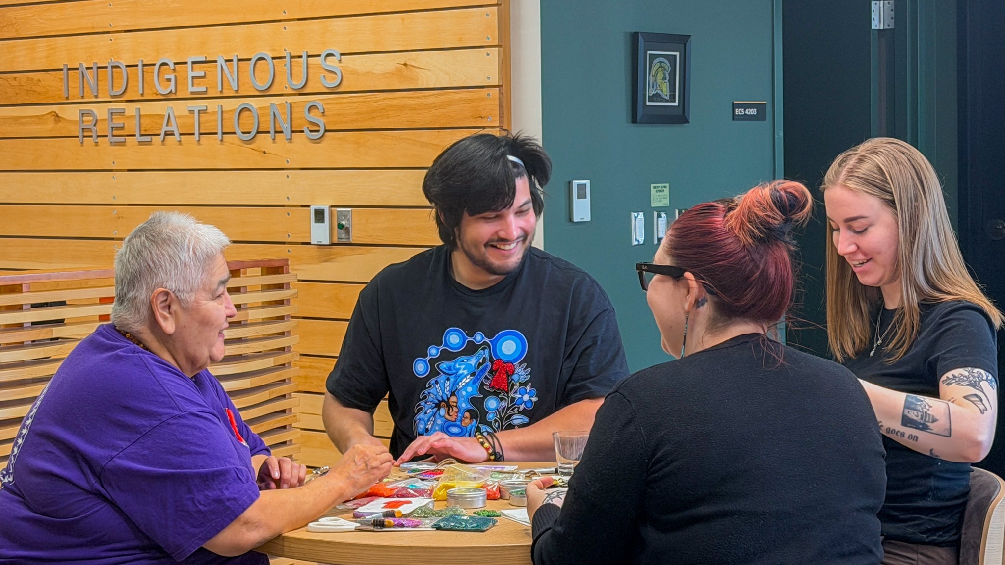 In the Visiting Aunties Program, Rhea Green connects with students and staff while they create their own beadwork 