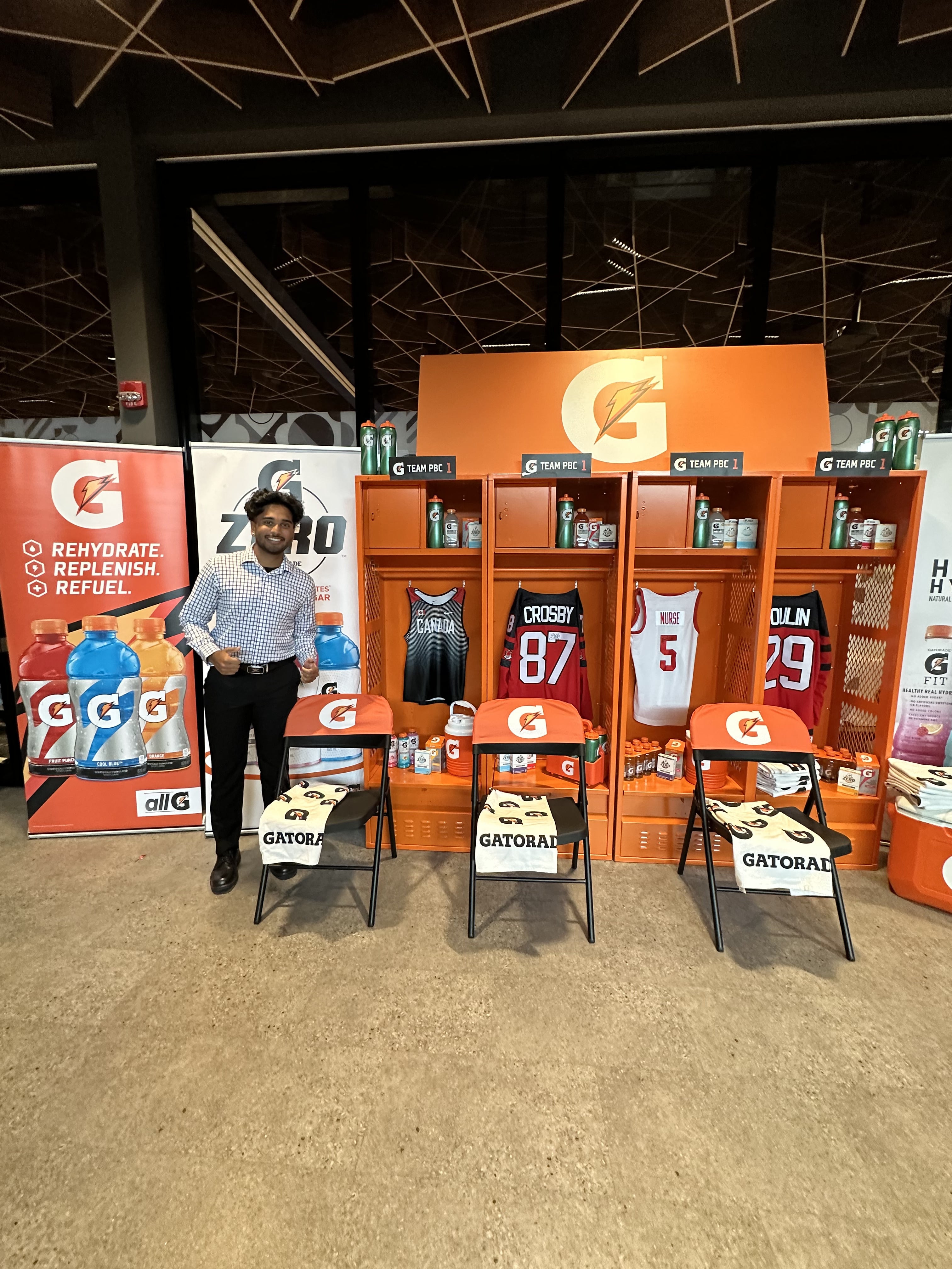Luke Manimendre standing in business gear in the middle of a Gatorade products display