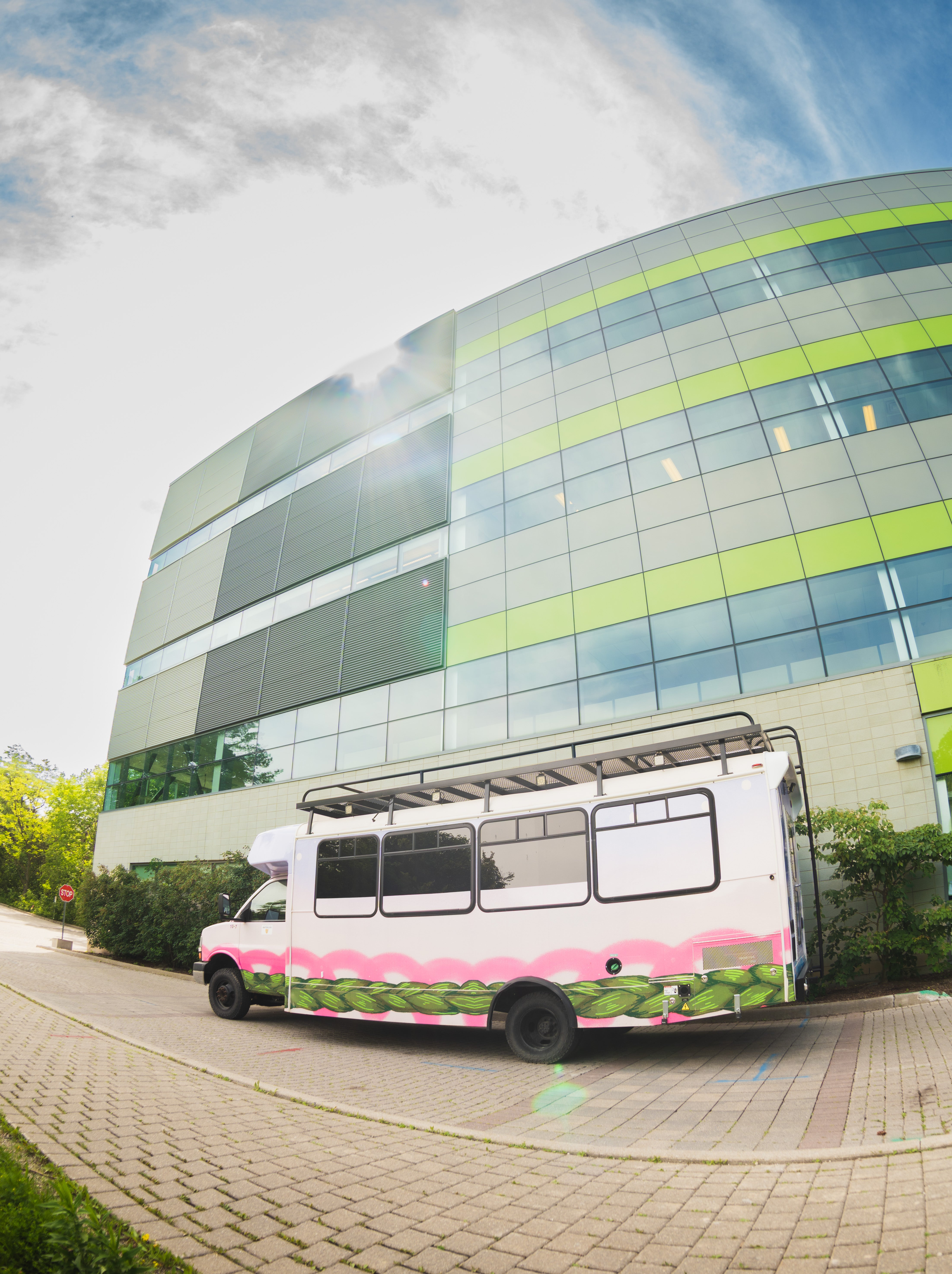 Front of bus showing sweetgrass woven through a daytime landscape.