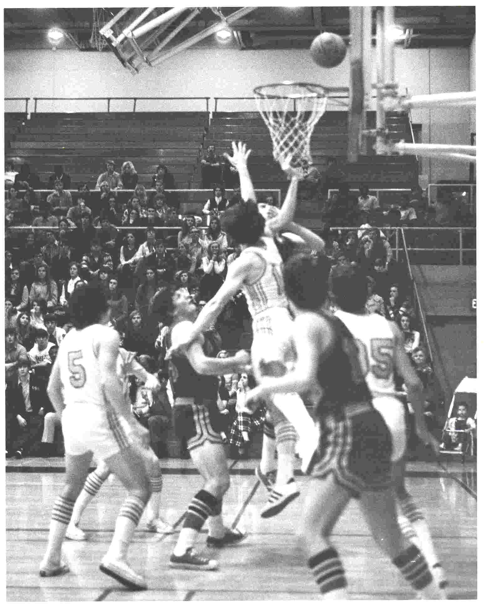 Waterloo Warriors players jump up to defend the opposing player's shot during a game