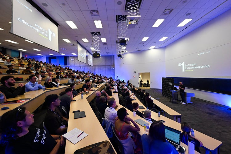 John Dick presents in front of a large crowd during 2026 Velocity Pitch Competition