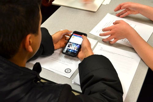 Student participating in user testing on a smartphone