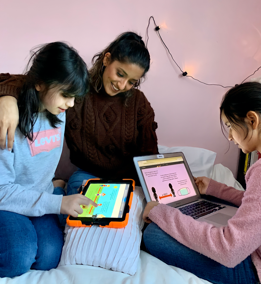 Sara Ibrahim reading the book with two children