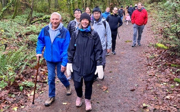 Jane walking in Discover Park with a group of alumni