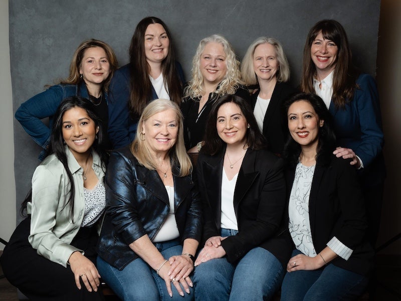 Nine members of the Women in Communications & Technology Mentoring Circles posing for a photo