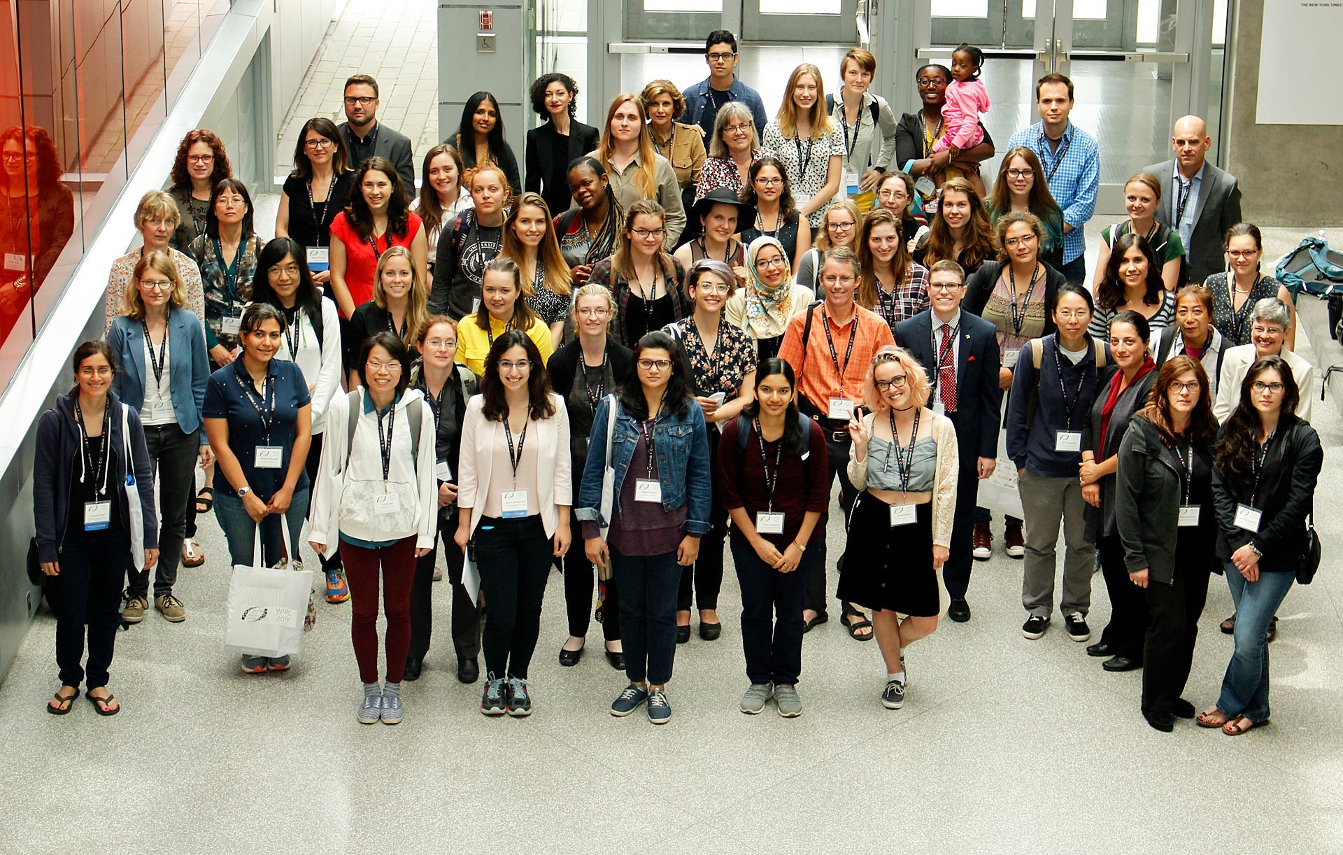 Conference attendees standing in lobby of Quantum Nano Centre