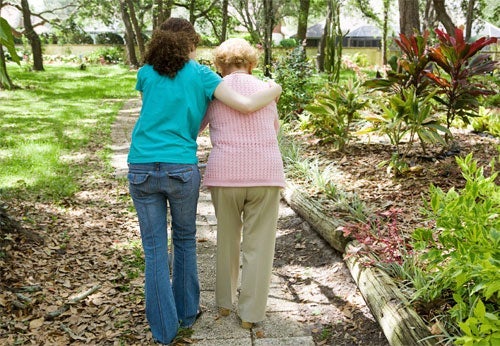 Young woman walks with senior woman