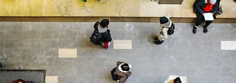 Aerial shot of 5 students walking and sitting.