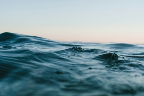 Photograph up close to waves in a body of water.