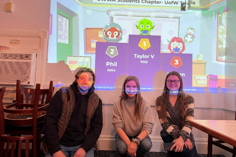 Winners of a Kahoot game in front of the game screen