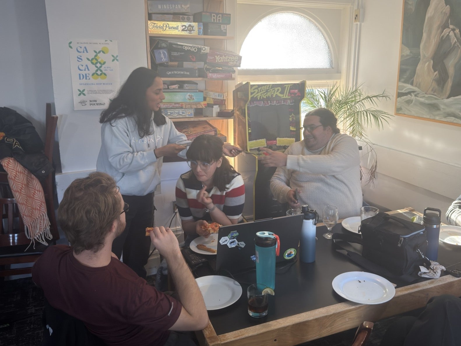 A team accepts their prize for coming first place in trivia