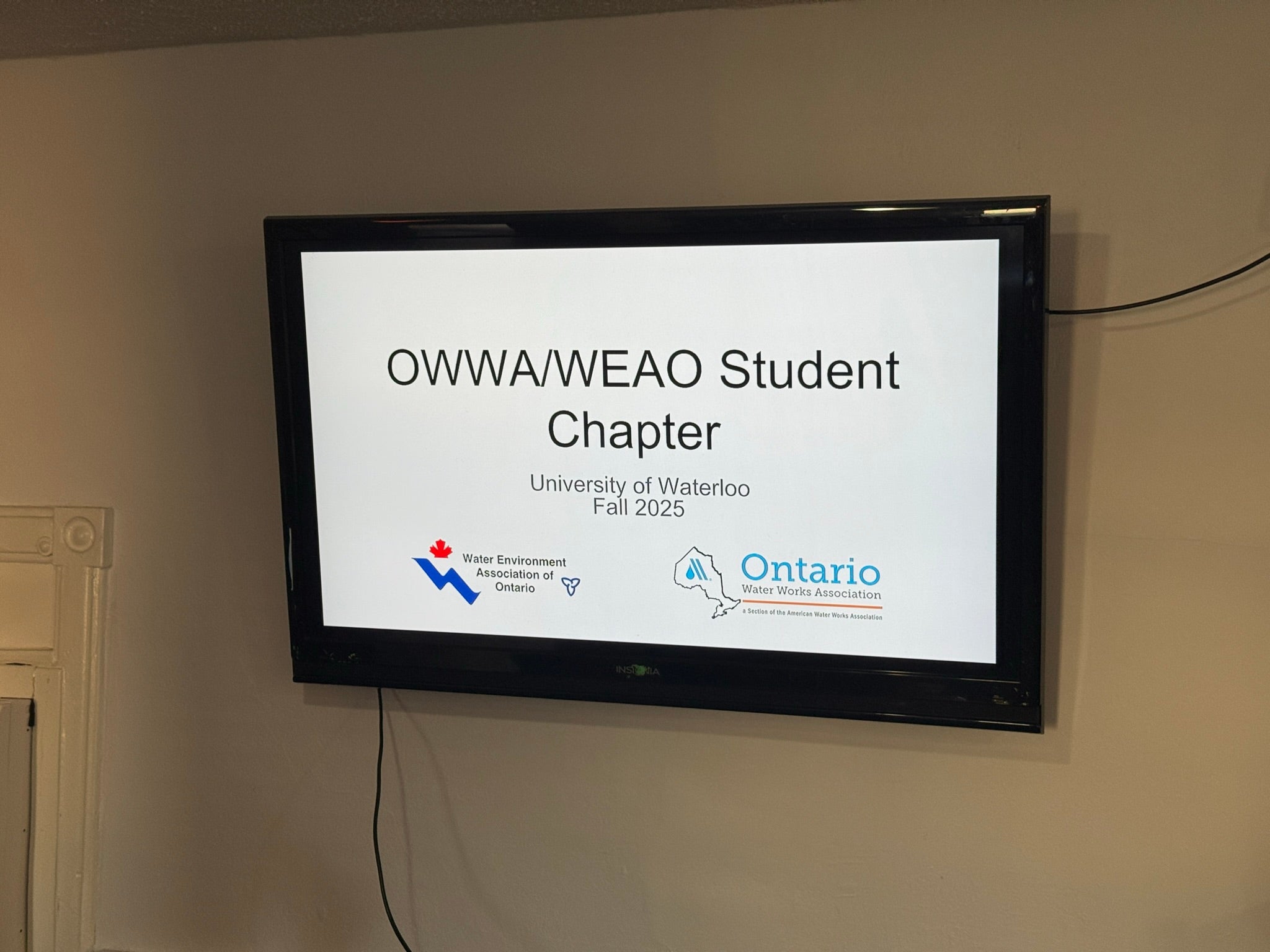 TV screen displaying the title slide of a presentation; "OWWA/WEAO Student Chapter"