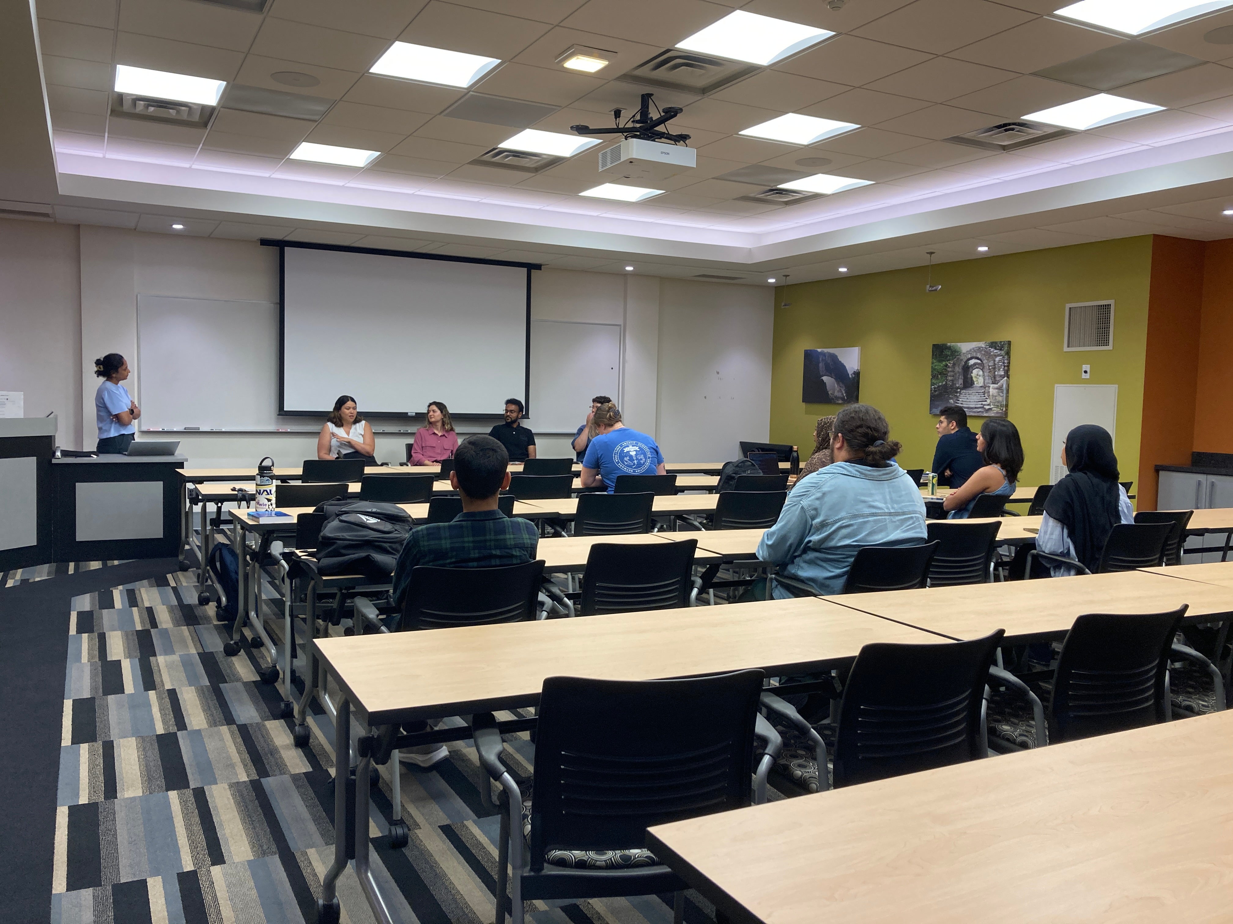 Room with students sitting next to tables at the career panel event