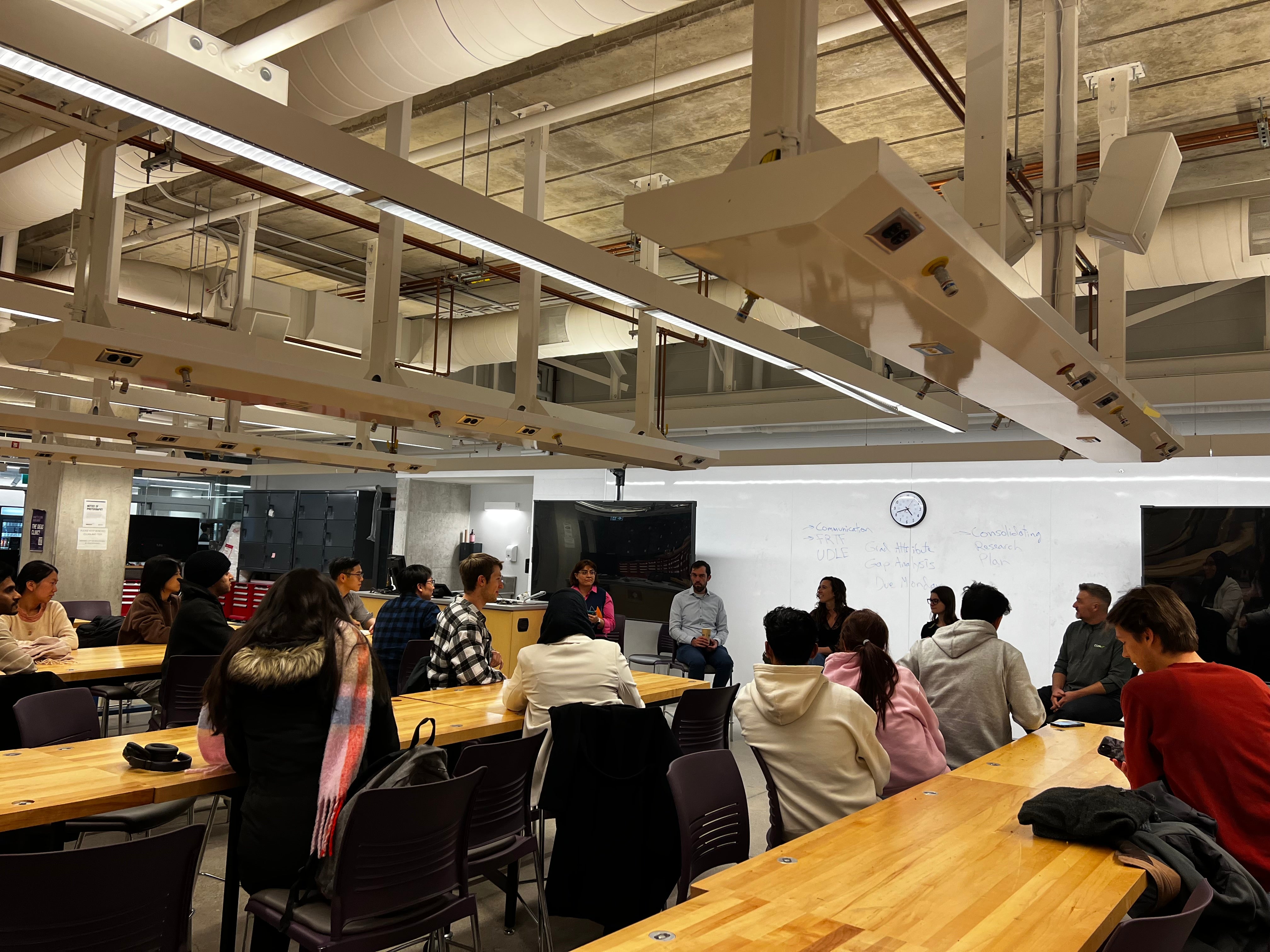 Image of the panel event organized, students sitting at tables listening to the panel
