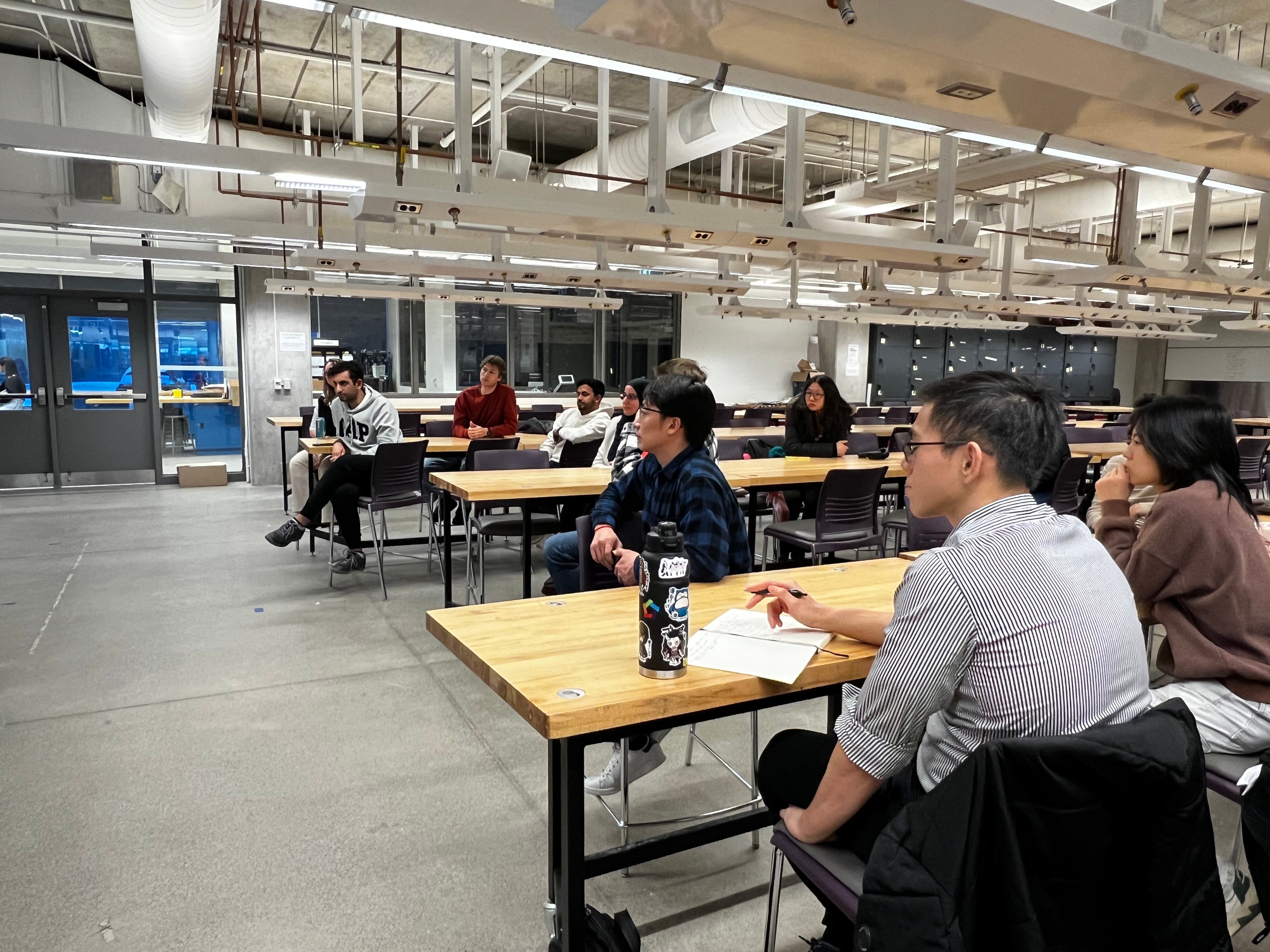 Image of the panel event organized, students sitting at tables listening to the panel