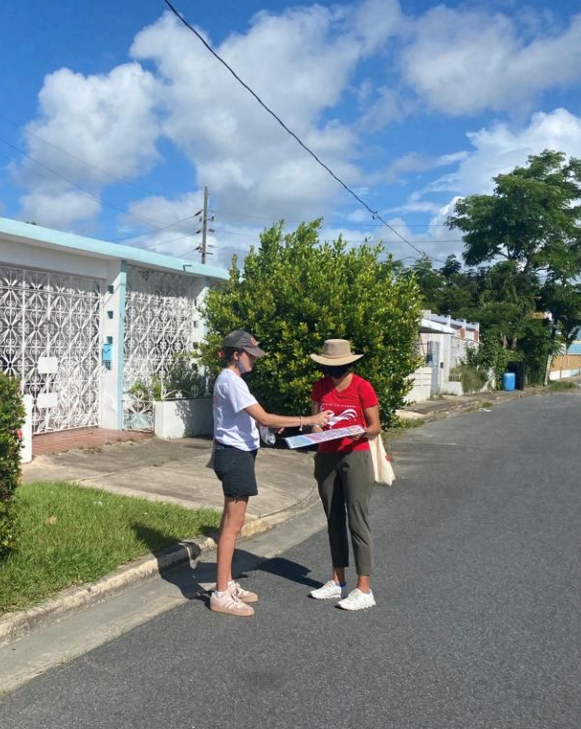 Two people standing on a suburban street in Puerto Rico.
