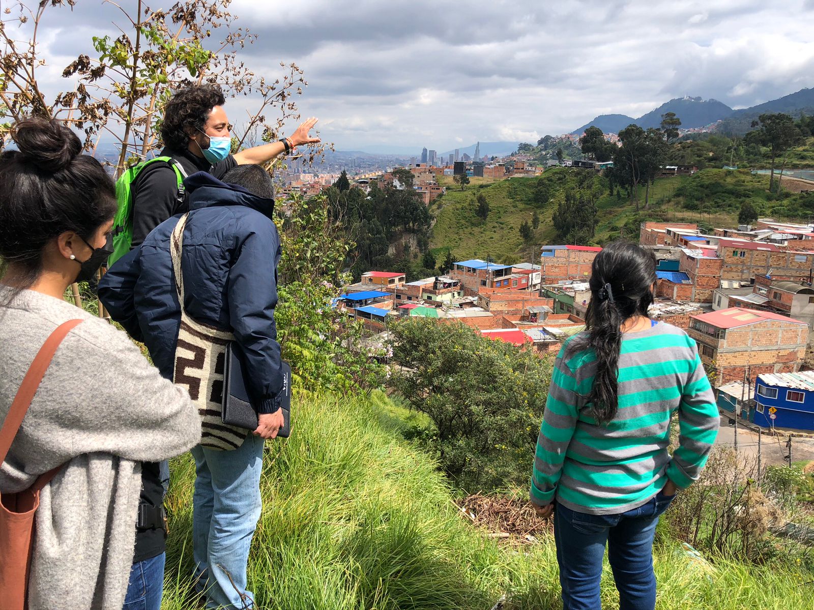 Three people looking over urban sprawl.