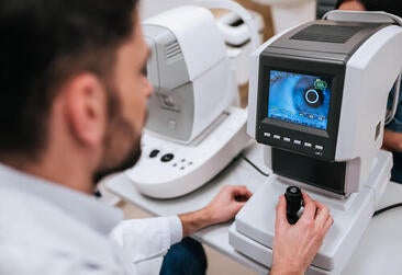 Clinician looks at an image using a fundus camera
