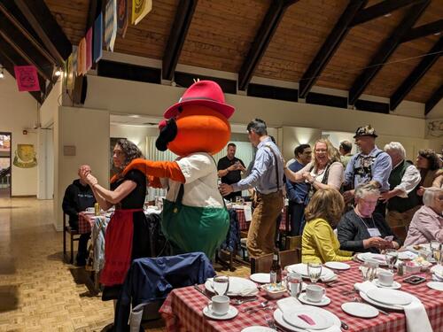 Attendees form a conga line at the Oktoberfest dinner.