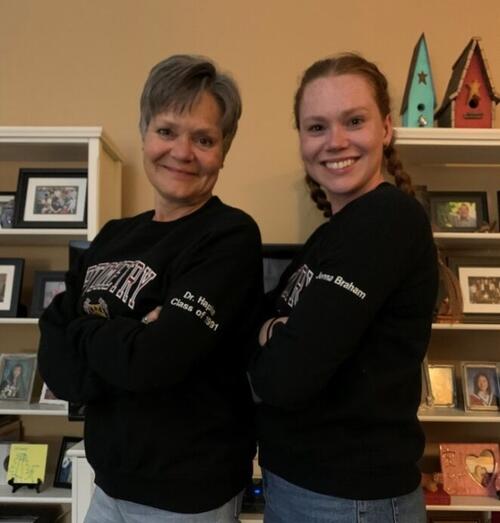 Manon Hapke and Jenna standing together and wearing their UW hoodies