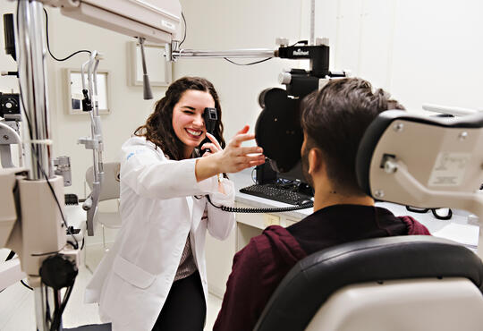 Optometry student with patient