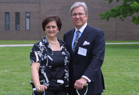 Marta Witer and Ian Ihnatowycz stand beside the School 