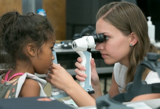 A child receives an eye exam