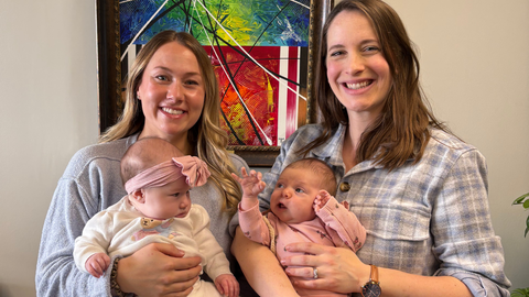 Rachel Green and Kelsey Gagnon stand with their newborns