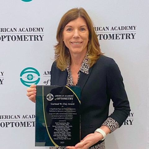 Dr. Deborah Jones holds her award plaque.