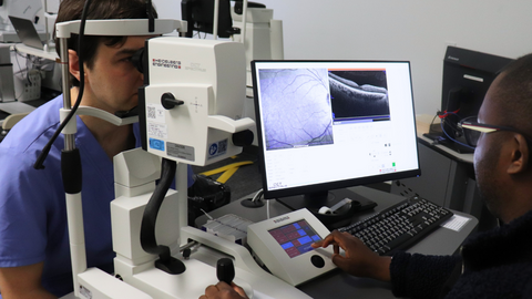 A patient look through medical equipment.