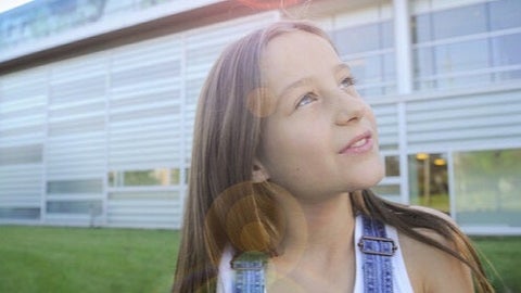 Photo of the School with a child in the foreground