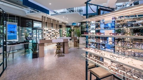 A view of Dr. Kerry Salsberg's clinic with rows of glasses on shelves.