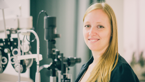 Kristine Dalton with optometry equipment in background