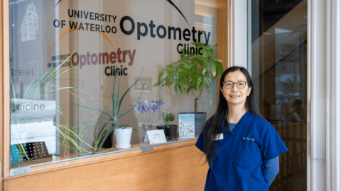 Dr. Lisa Woo stands in front of the entrance to the School's Kitchener clinic.