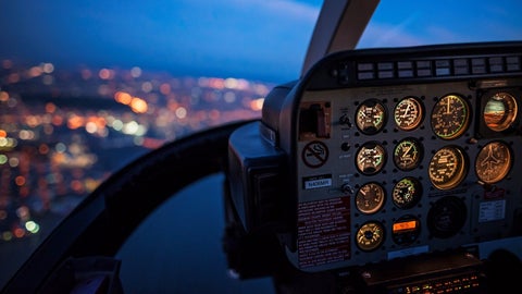 Night view of a city from the cockpit of a plane