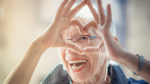 A person creates a heart shape with their hands