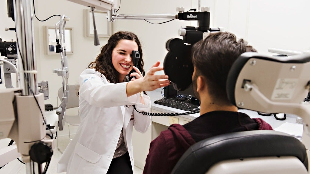 Optometry student with patient