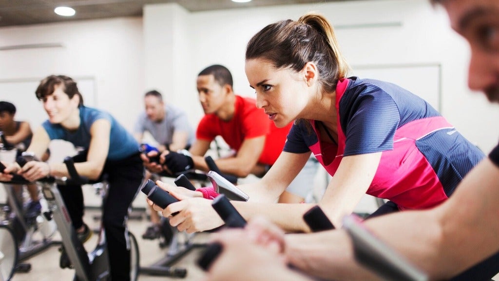 Athletes training on exercise bicycles