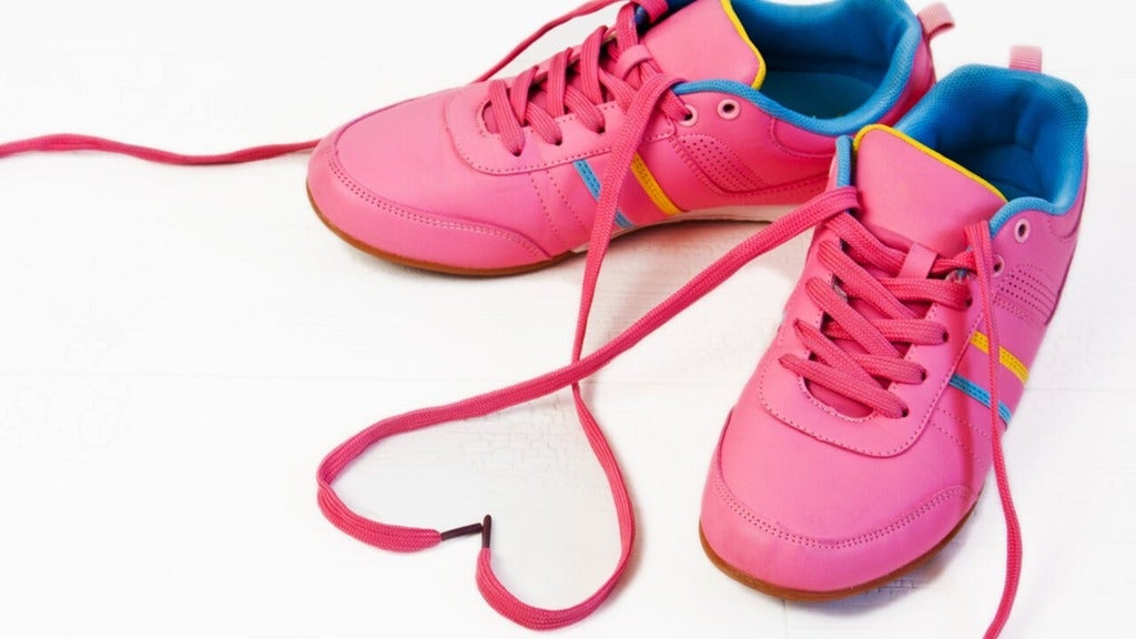 Pink shoes with laces forming at heart