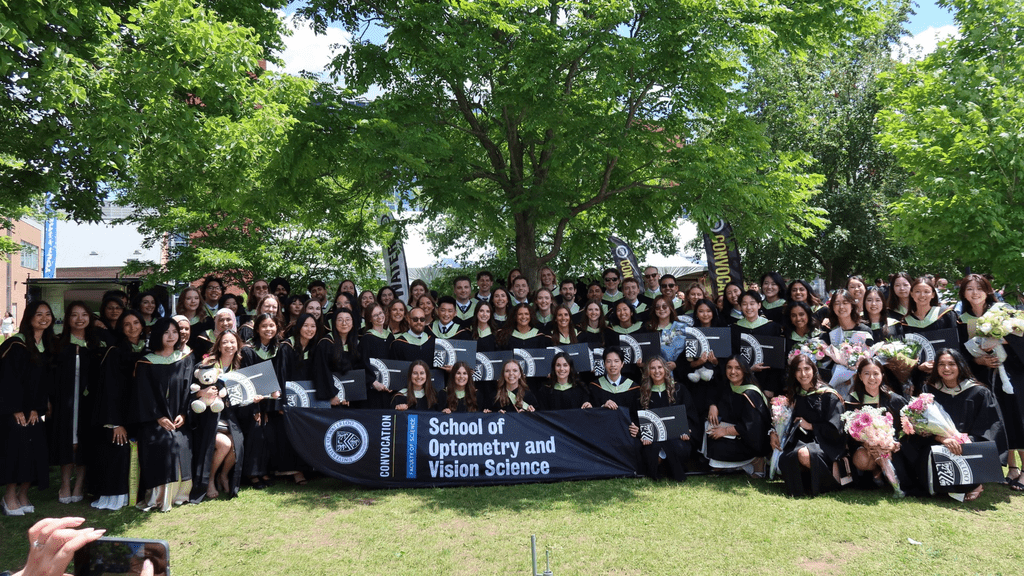 Group photo of class of 2026 on on grass with trees in back
