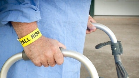 Elderly person using a walker for support