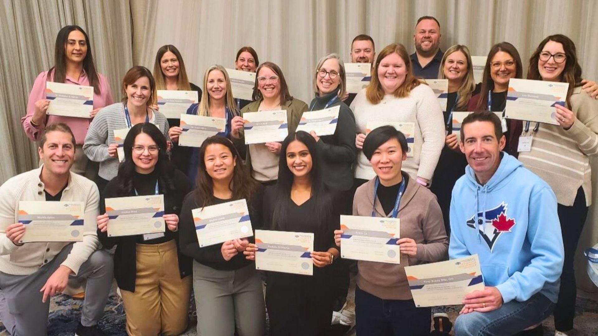 Attendees hold their certificates at the CAO leadership development program.